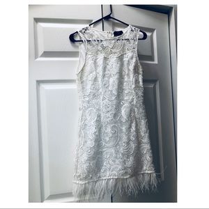 Women’s white lace dress with feather trim